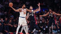 New York Knicks center Karl-Anthony Towns (32) looks to pass as Cleveland Cavaliers forward Dean Wade (32) defends during the first quarter at Madison Square Garden.