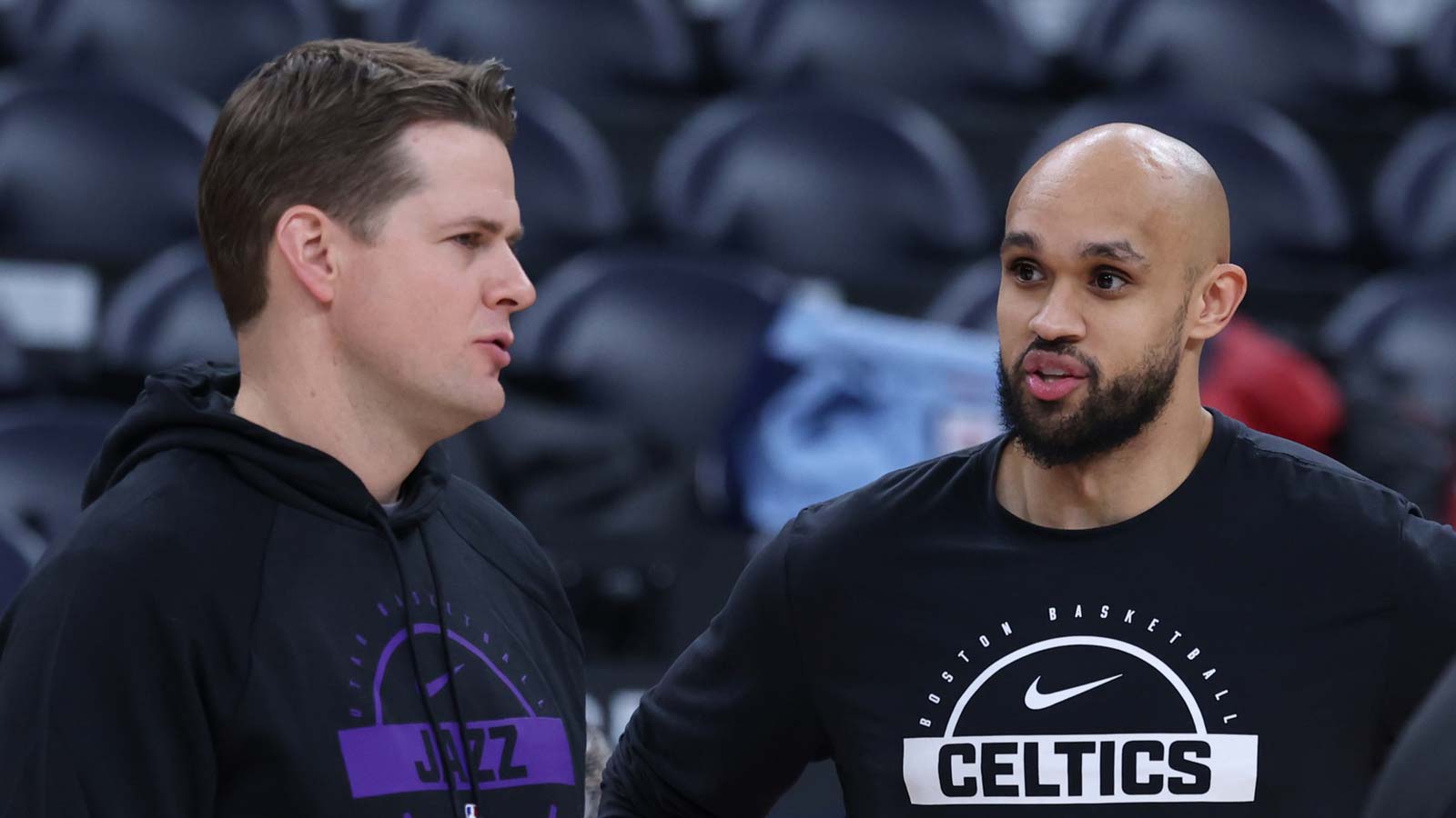 Jazz head coach Will Hardy (left) and Boston Celtics guard Derrick White (right) speak before a game at Delta Center
