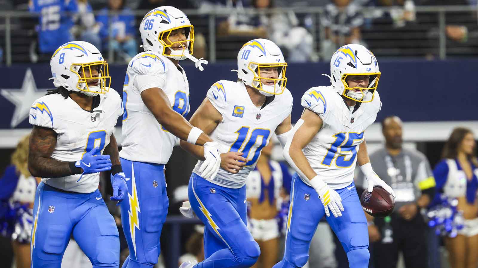 Los Angeles Chargers wide receiver Ladd McConkey (15) returns to the bench with running back Omarion Hampton (8), tight end Will Dissly (89) and quarterback Justin Herbert (10) after catching a touchdown pass from Herbert against the Dallas Cowboys during the second quarter at AT&T Stadium.