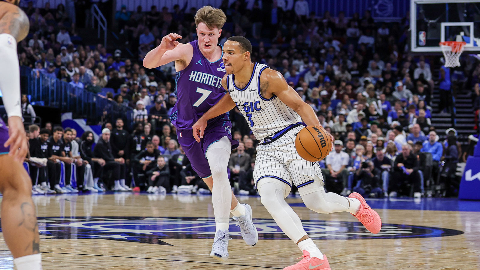 Orlando Magic forward Paolo Banchero (5) drives around Charlotte Hornets guard Kon Knueppel (7) during the first quarter at Kia Center.