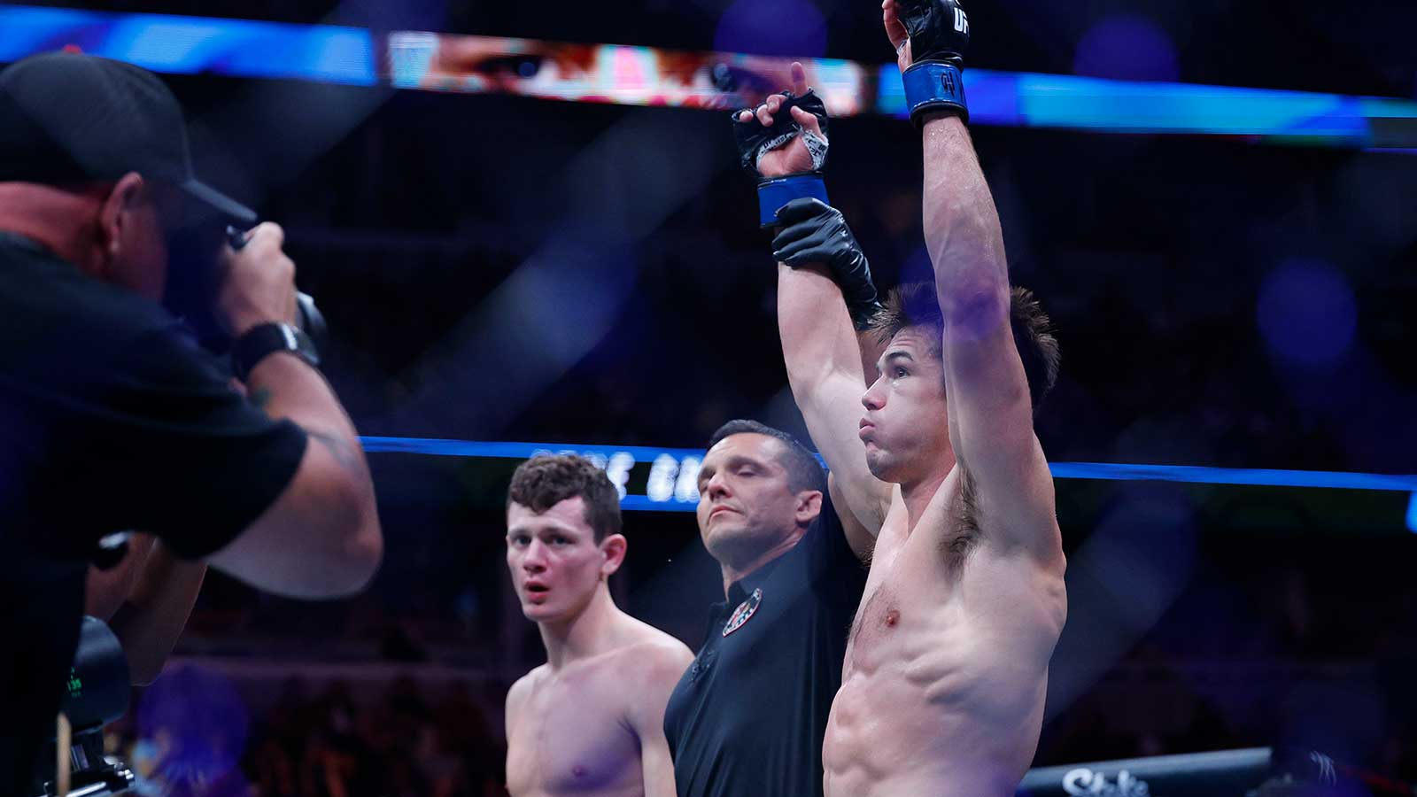 Alexander Hernandez (blue gloves) reacts after the fight against Chase Hooper (red gloves) during UFC 319 at United Center.