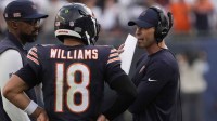 Chicago Bears head coach Ben Johnson talks with quarterback Caleb Williams (18)