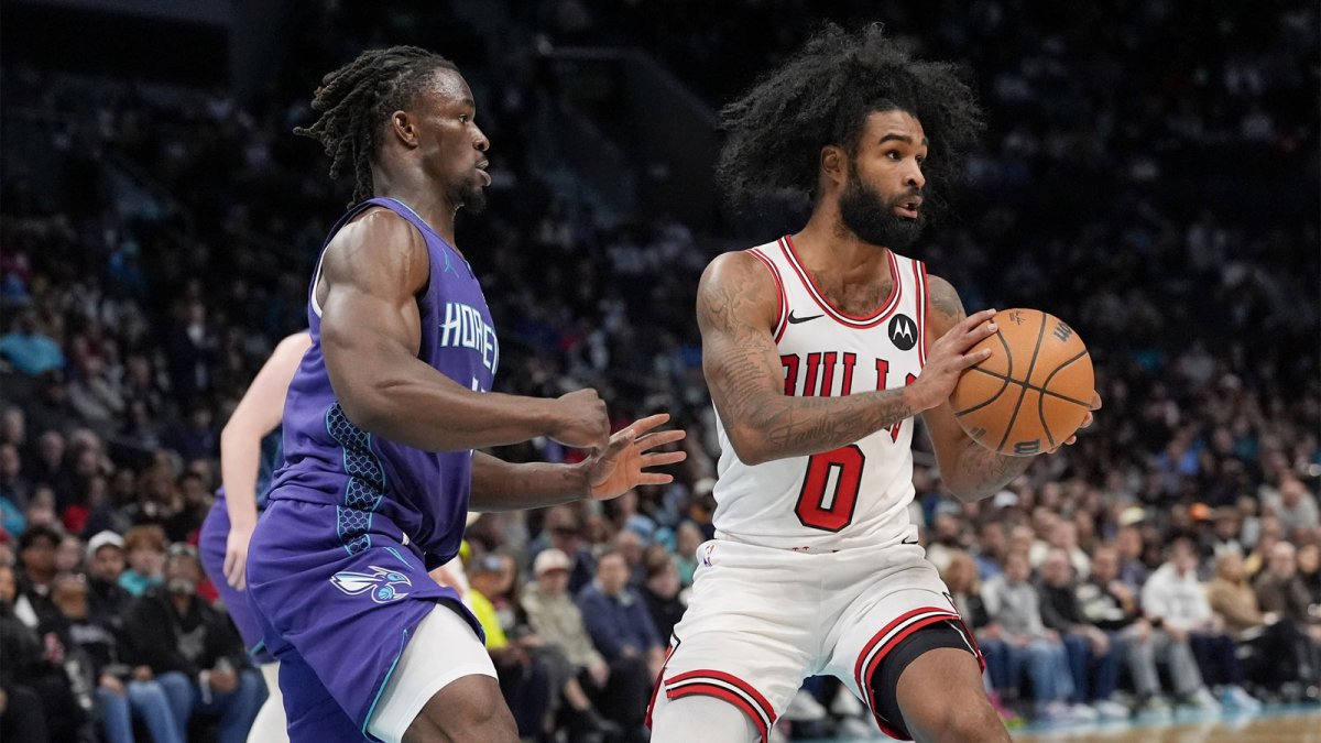 Dec 12, 2025; Charlotte, North Carolina, USA; Chicago Bulls guard Coby White (0) passes the ball under pressure by Charlotte Hornets guard Sion James (4) during the second half at Spectrum Center. Mandatory Credit: Jim Dedmon-Imagn Images