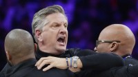 Staff restrains Minnesota Timberwolves head coach Chris Finch after a referee ejected him for chasing him down on a call for the Oklahoma City Thunder in the first quarter at Target Center.
