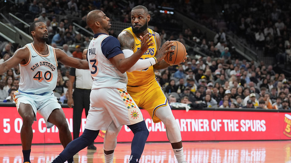 Los Angeles Lakers forward LeBron James (23) dribbles against San Antonio Spurs guard Chris Paul (3) in the second half at Frost Bank Center. 