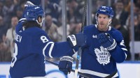 Toronto Maple Leafs defenseman Jake McCabe (22) celebrates with defenseman Chris Tanev (8) after scoring a goal against the Nashville Predators in the first period at Scotiabank Arena.