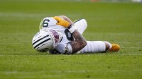 Green Bay Packers wide receiver Christian Watson (9) lies on the field following an injury during the third quarter against the Denver Broncos at Empower Field at Mile High.