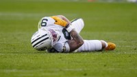 Green Bay Packers wide receiver Christian Watson (9) lies on the field following an injury during the third quarter against the Denver Broncos at Empower Field at Mile High.
