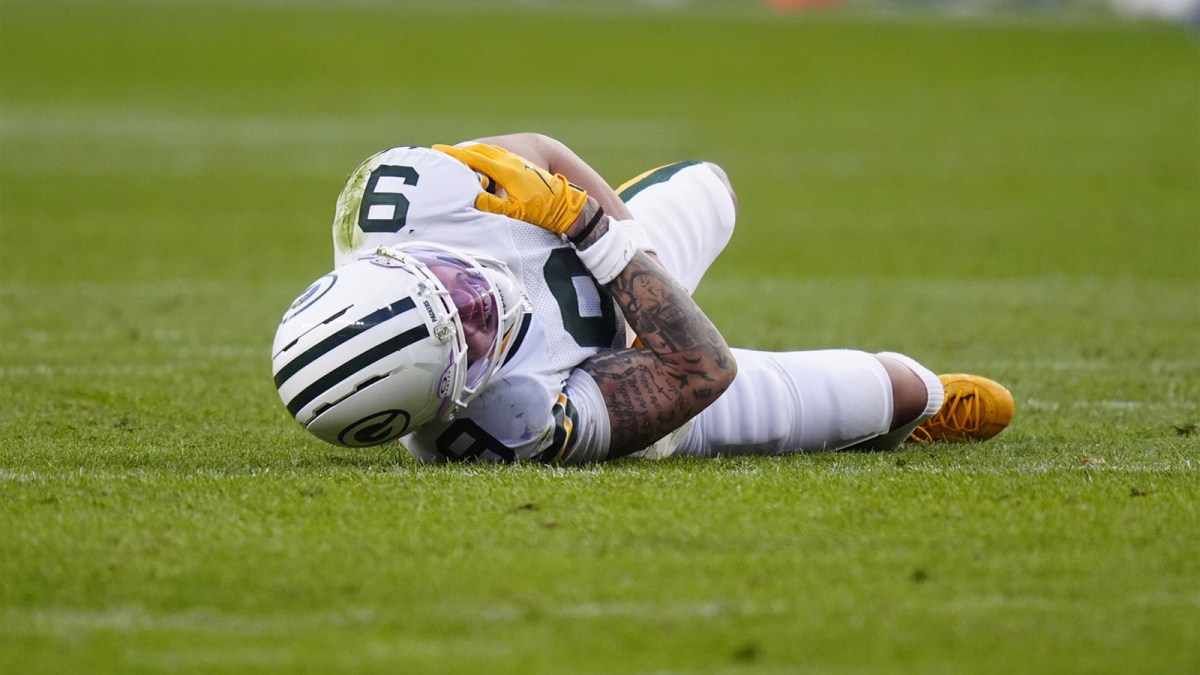 Green Bay Packers wide receiver Christian Watson (9) lies on the field following an injury during the third quarter against the Denver Broncos at Empower Field at Mile High.
