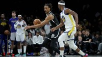 Brooklyn Nets center Nic Claxton (33) brings the ball up court against Golden State Warriors forward Jimmy Butler III (10) during the fourth quarter at Barclays Center