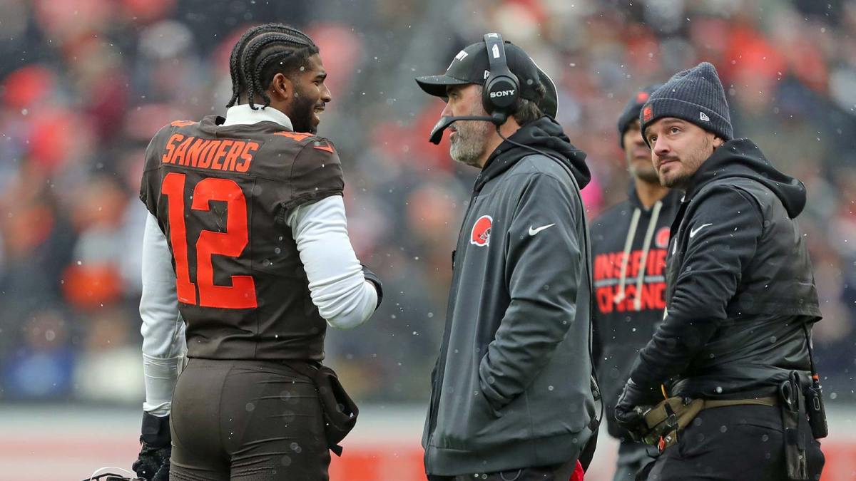 Cleveland Browns quarterback Shedeur Sanders (12) talks with coach Kevin Stefanski during a game against the Tennessee Titans on Dec. 7, 2025, in Cleveland.