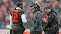 Cleveland Browns quarterback Shedeur Sanders (12) talks with coach Kevin Stefanski during a game against the Tennessee Titans on Dec. 7, 2025, in Cleveland.