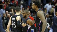 Clippers guard Austin Rivers (25), guard Chris Paul (3) and center DeAndre Jordan (6) celebrate their win against the Atlanta Hawks at Philips Arena. The Clippers won 85-83