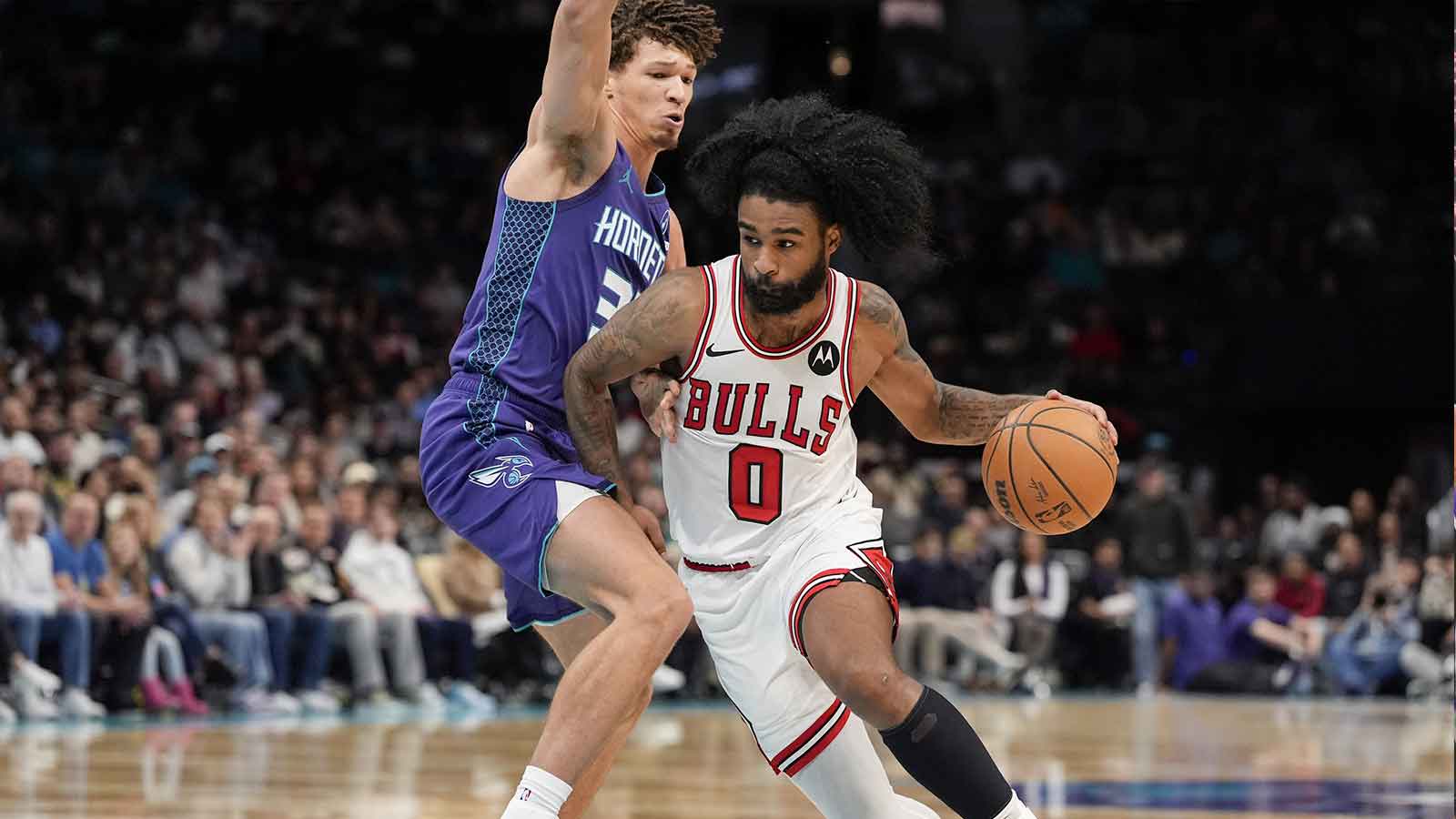 Chicago Bulls guard Coby White (0) drives to the basket against Charlotte Hornets forward Tidjane Salaun (31) during the second half at Spectrum Center.