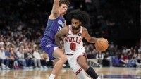 Chicago Bulls guard Coby White (0) drives to the basket against Charlotte Hornets forward Tidjane Salaun (31) during the second half at Spectrum Center.
