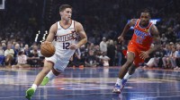 Phoenix Suns guard Collin Gillespie (12) drives to the basket around Oklahoma City Thunder guard Cason Wallace (22) during the first quarter at Paycom Center.