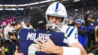 Indianapolis Colts quarterback Philip Rivers (17) hugs Seattle Seahawks quarterback Jalen Milroe (6) following a victory by the Seattle Seahawks at Lumen Field.