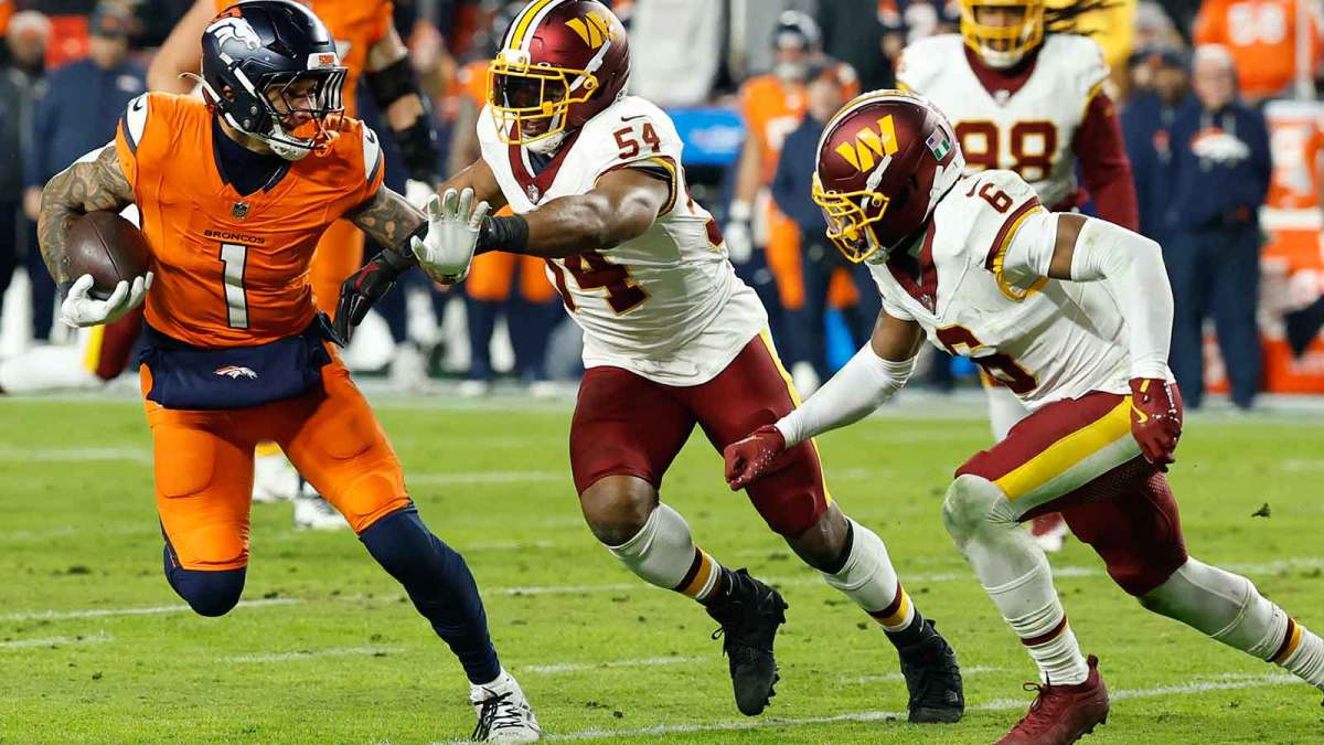 Denver Broncos tight end Evan Engram (1) runs with the ball as Washington Commanders linebacker Bobby Wagner (54) and Commanders cornerback Noah Igbinoghene (6) chase in the third quarter at Northwest Stadium