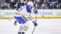 Buffalo Sabres defenseman Conor Timmins (21) passes the puck during the second period against the Seattle Kraken at Climate Pledge Arena.