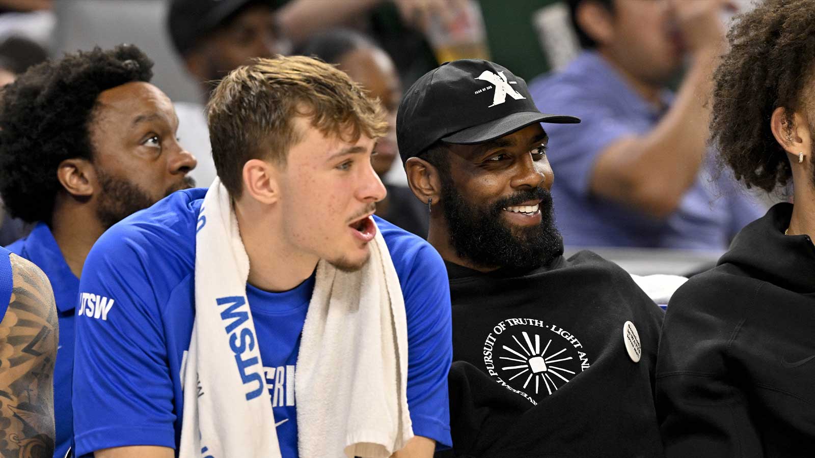 Dallas Mavericks forward Cooper Flagg (left) and guard Kyrie Irving (right) watch the game against the Oklahoma City Thunder during the second half at Dickie's Arena.