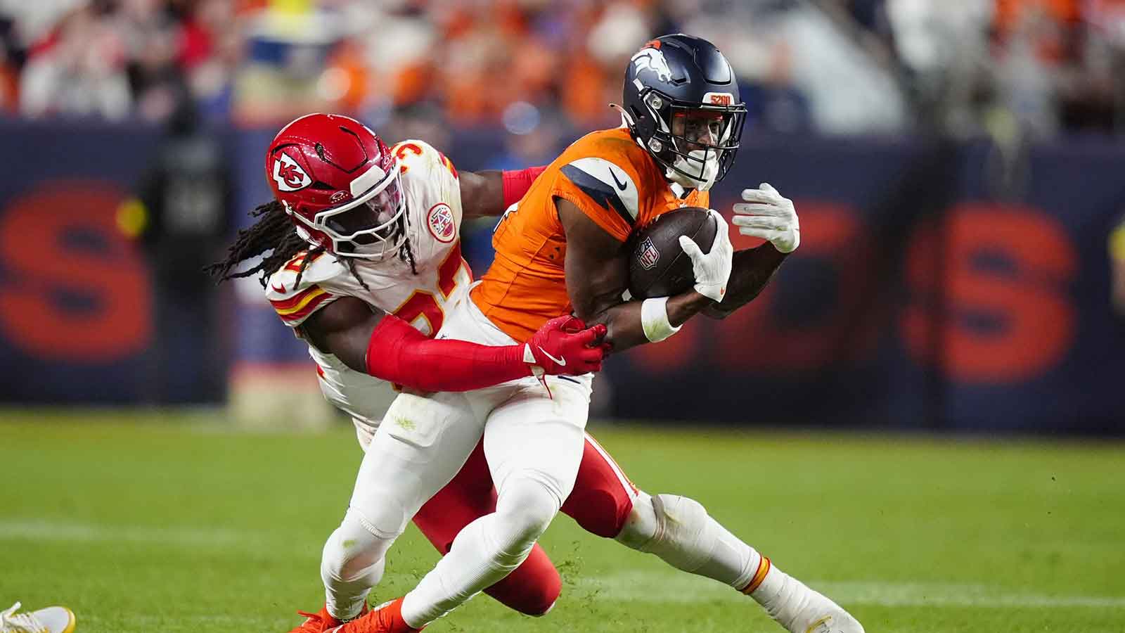 Kansas City Chiefs linebacker Nick Bolton (32) tackles Denver Broncos wide receiver Courtland Sutton (14) in the fourth quarter at Empower Field at Mile High.
