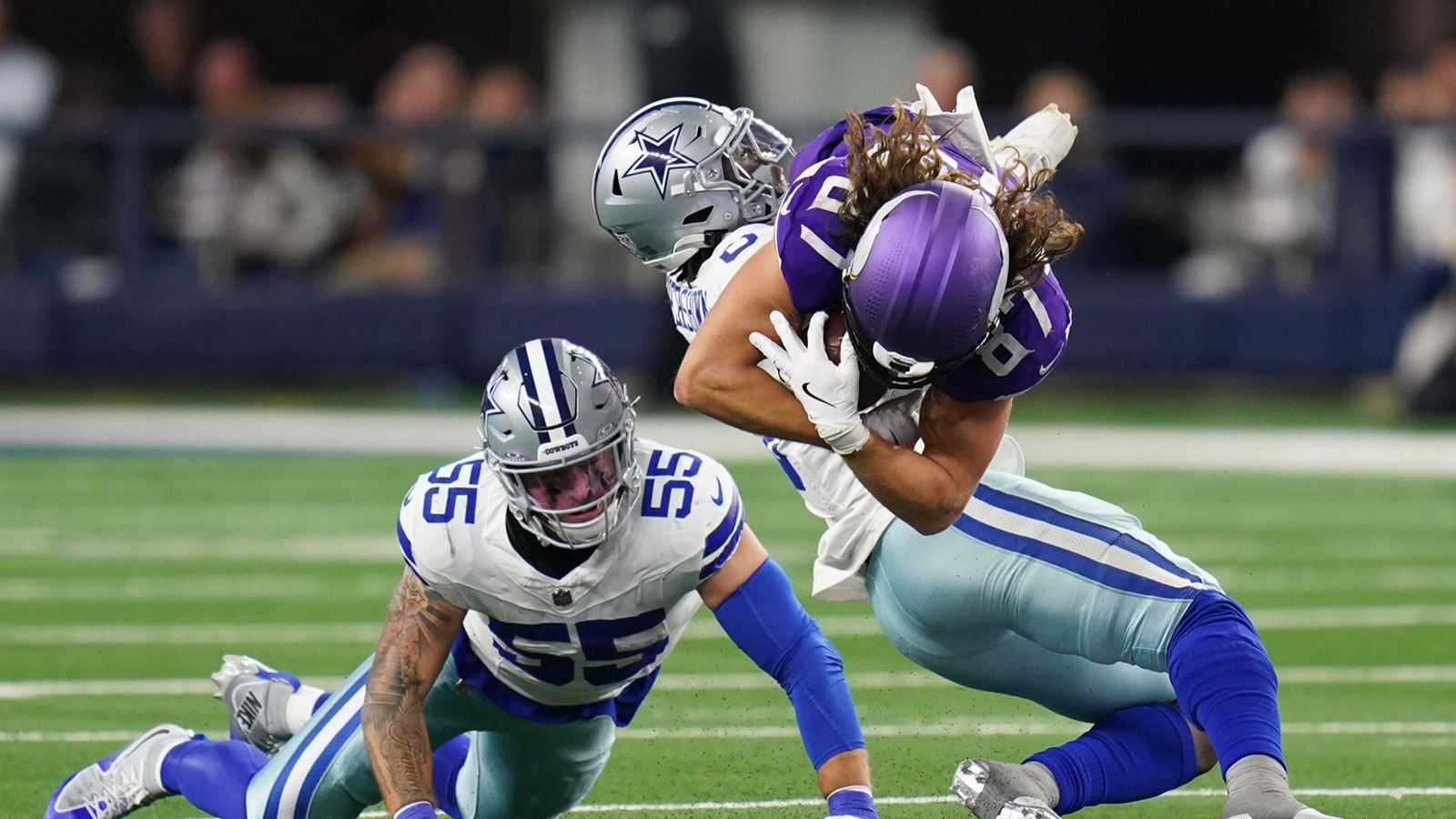 Minnesota Vikings tight end T.J. Hockenson (87) is tackled by Dallas Cowboys linebacker Demarvion Overshown (0) during the second half at AT&T Stadium.