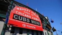 Detailed view of the marquee sign outside the stadium showing a Chicago Cubs win after defeating the Pittsburgh Pirates at Wrigley Field.