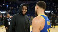 Minnesota Timberwolves guard Anthony Edwards (5) chats with Golden State Warriors guard Stephen Curry (30) at center court after the game at Chase Center.