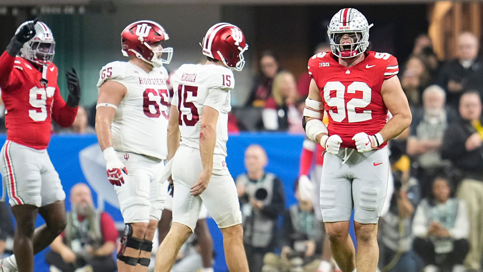 Ohio State Buckeyes defensive end Caden Curry (92) celebrates beside Indiana Hoosiers quarterback Fernando Mendoza (15) during the first half of the Big Ten Conference championship game at Lucas Oil Stadium in Indianapolis on Dec. 6, 2025.