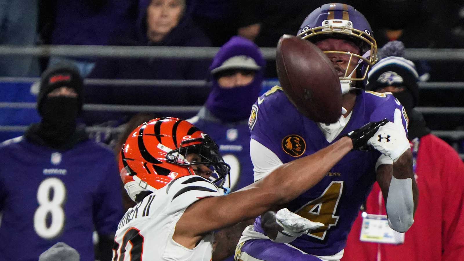 Bengals DJ Turner II (20) disrupts the Ravens ball carrier during their game at M&T Bank Stadium on Thanksgiving Thursday November 27, 2025. The Bengals won the game with a final score of 33-14.