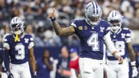 Dallas Cowboys quarterback Dak Prescott (4) signals towards the sideline following a play against the Los Angeles Chargers during the third quarter at AT&T Stadium.