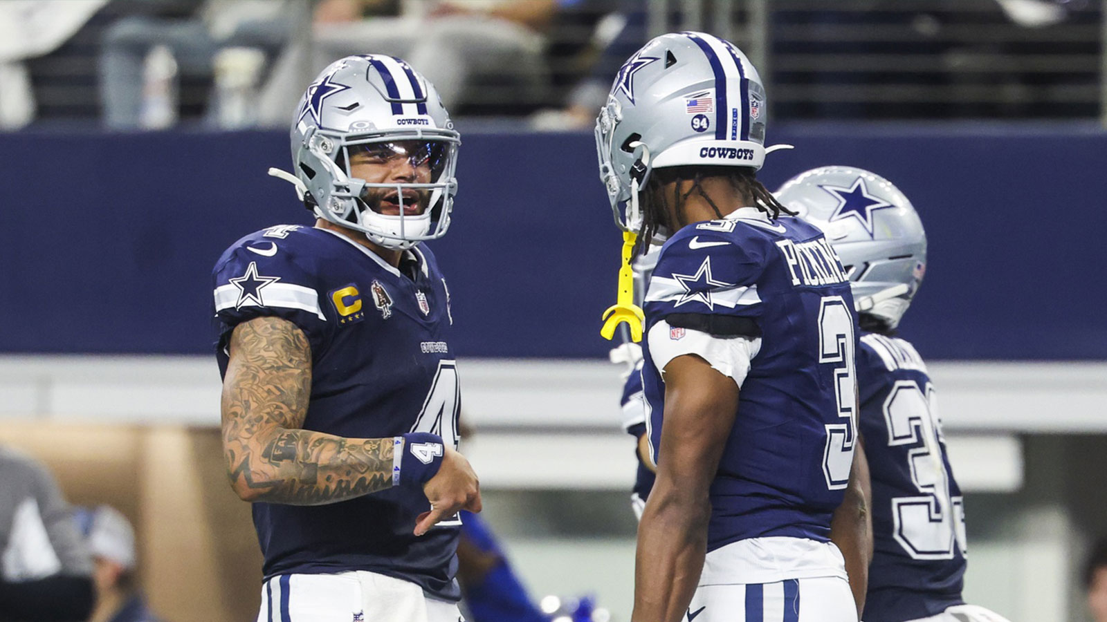 Dallas Cowboys quarterback Dak Prescott (4) celebrates with wide receiver George Pickens (3) after a touchdown pass caught by Pickens during the second quarter at AT&T Stadium.