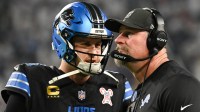 Detroit Lions quarterback Jared Goff (16) speaks with head coach Dan Campbell in the second quarter against the Minnesota Vikings at U.S. Bank Stadium.