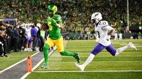 Oregon Ducks quarterback Dante Moore (5) rushes for a touchdown as James Madison Dukes safety Tyler Brown (13) defends during the first quarter at Autzen Stadium.