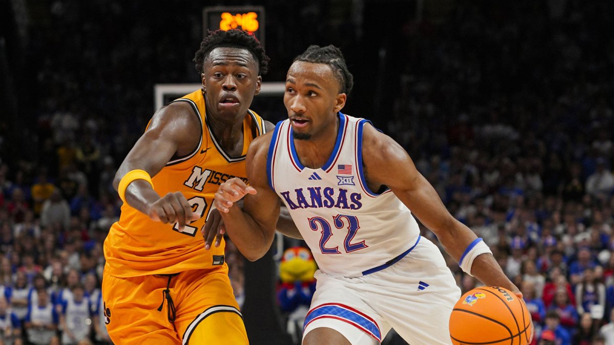 Kansas Jayhawks guard Darryn Peterson (22) drives against Missouri Tigers forward Mark Mitchell (25) during the first half at T-Mobile Center.