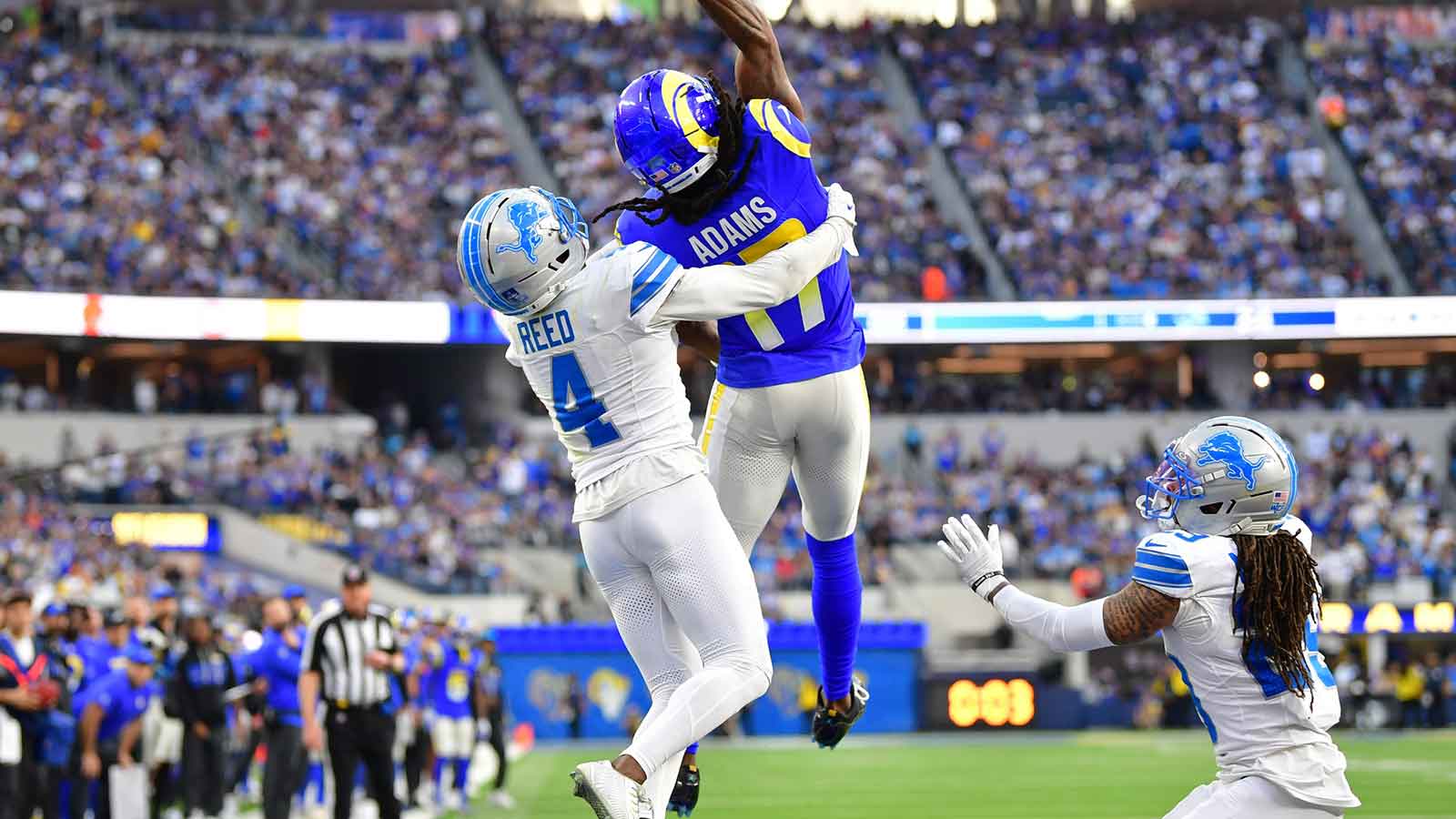Los Angeles Rams wide receiver Davante Adams (17) goes up for a pass against Detroit Lions cornerback D.J. Reed (4) during the second quarter at SoFi Stadium.