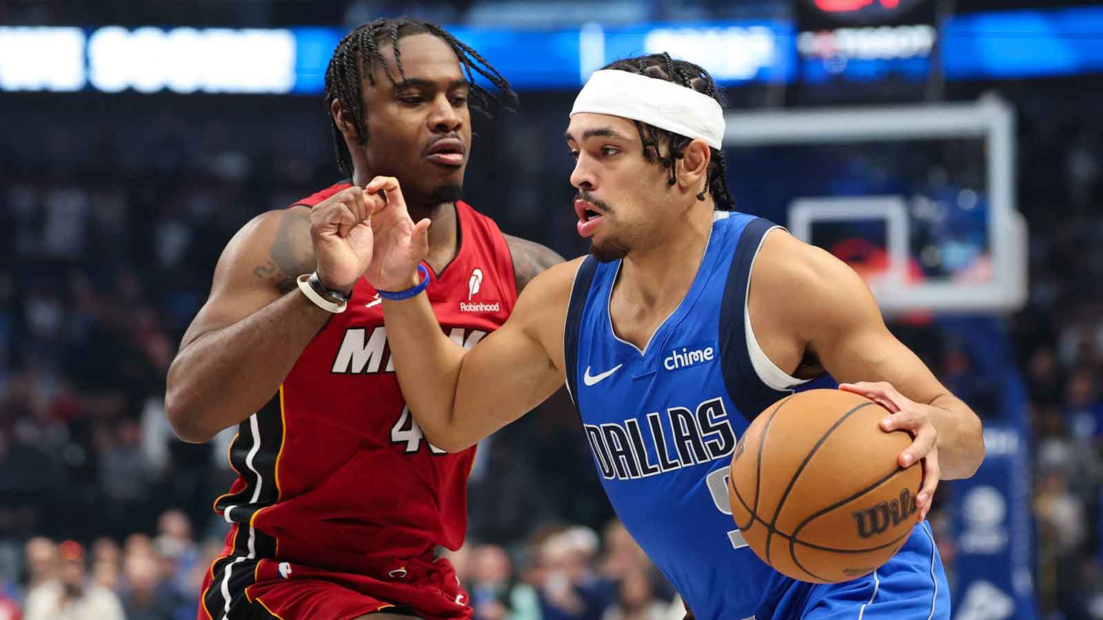 Dallas Mavericks guard Ryan Nembhard (9) drives to the basket as Miami Heat guard Davion Mitchell (45) defends during the first quarter at American Airlines Center.