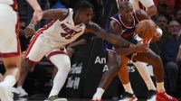 Miami Heat guard Davion Mitchell (45) tips the ball away from Los Angeles Clippers guard Kris Dunn (8) during the second half at Kaseya Center.