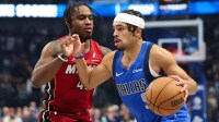 Dallas Mavericks guard Ryan Nembhard (9) drives to the basket as Miami Heat guard Davion Mitchell (45) defends during the first quarter at American Airlines Center.