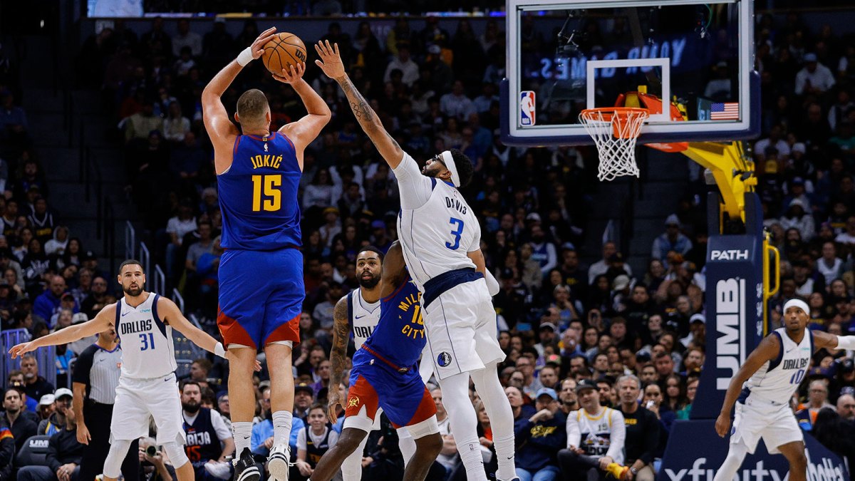 Denver Nuggets center Nikola Jokic (15) attempts a shot as Dallas Mavericks forward Anthony Davis (3) defends in the third quarter at Ball Arena.