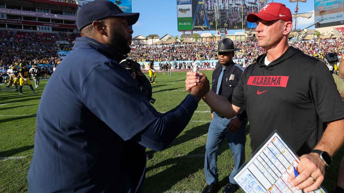 Michigan Wolverines head coach Sherrone Moore greets Alabama Crimson Tide head coach Kalen Deboer after the ReliaQuest Bowl at Raymond James Stadium.