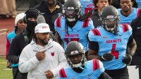 Delaware State head coach DeSean Jackson, left, leads his team onto the field before taking on South Carolina State at Alumni Stadium on Nov. 22, 2025.