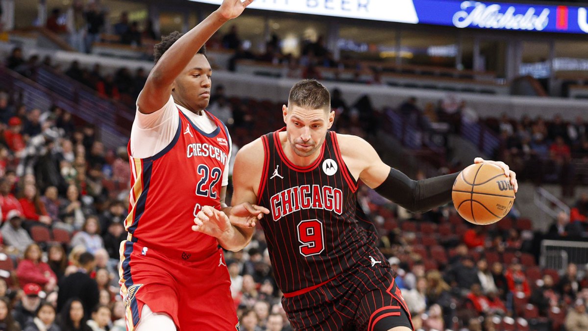 Dec 14, 2025; Chicago, Illinois, USA; Chicago Bulls center Nikola Vucevic (9) drives to the basket against New Orleans Pelicans center Derik Queen (22) during the first half at United Center. Mandatory Credit: Kamil Krzaczynski-Imagn Images
