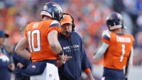 Denver Broncos head coach Sean Payton talks with quarterback Bo Nix (10) during the second quarter against the Green Bay Packers at Empower Field at Mile High.