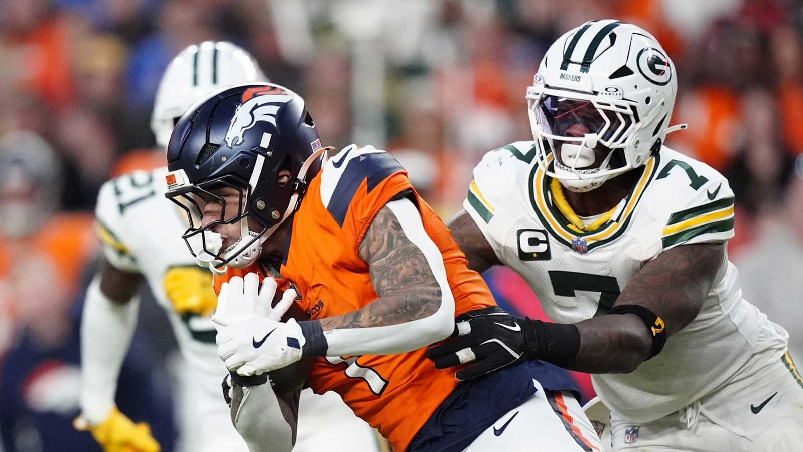 Denver Broncos tight end Evan Engram (1) runs for a gain past Green Bay Packers linebacker