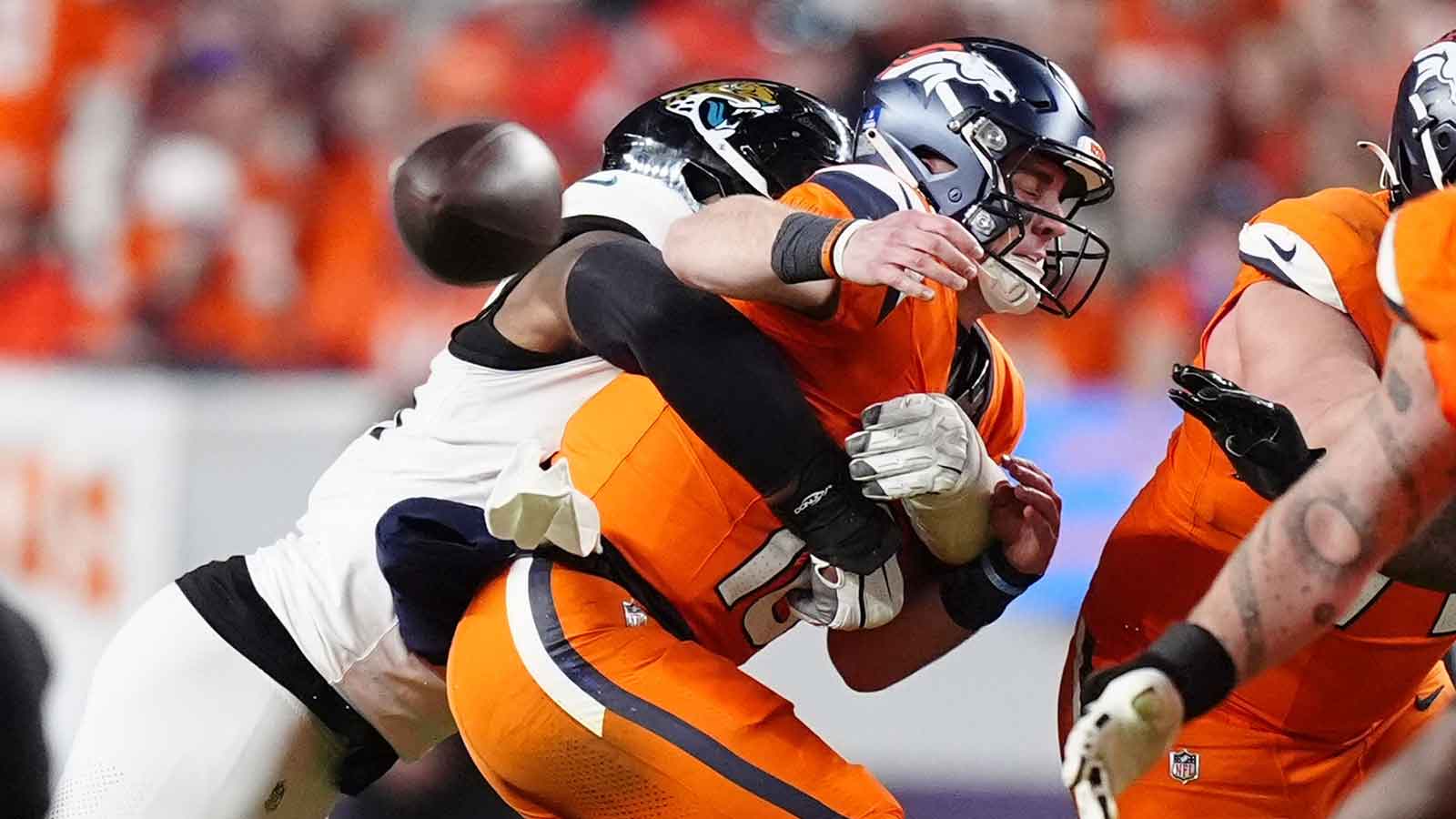 Jacksonville Jaguars defensive end Travon Walker (44) hits Denver Broncos quarterback Bo Nix (10) during the second half at Empower Field at Mile High.