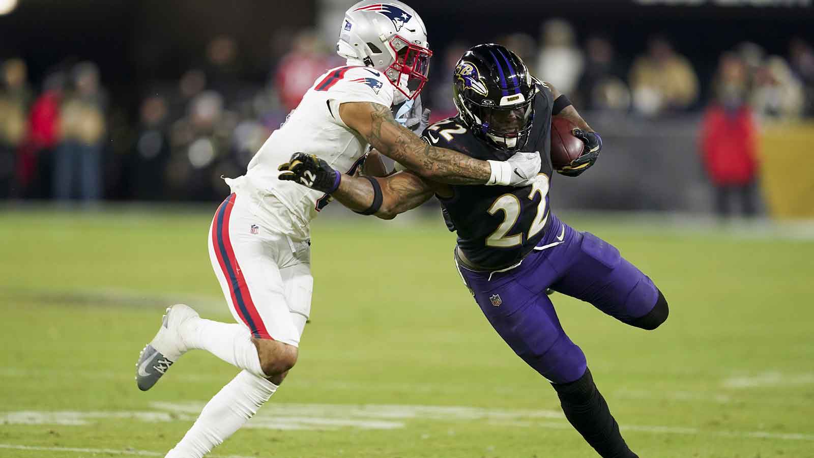 Baltimore Ravens running back Derrick Henry (22) runs the ball against New England Patriots cornerback Christian Gonzalez (0) during the second half of the game at M&T Bank Stadium.