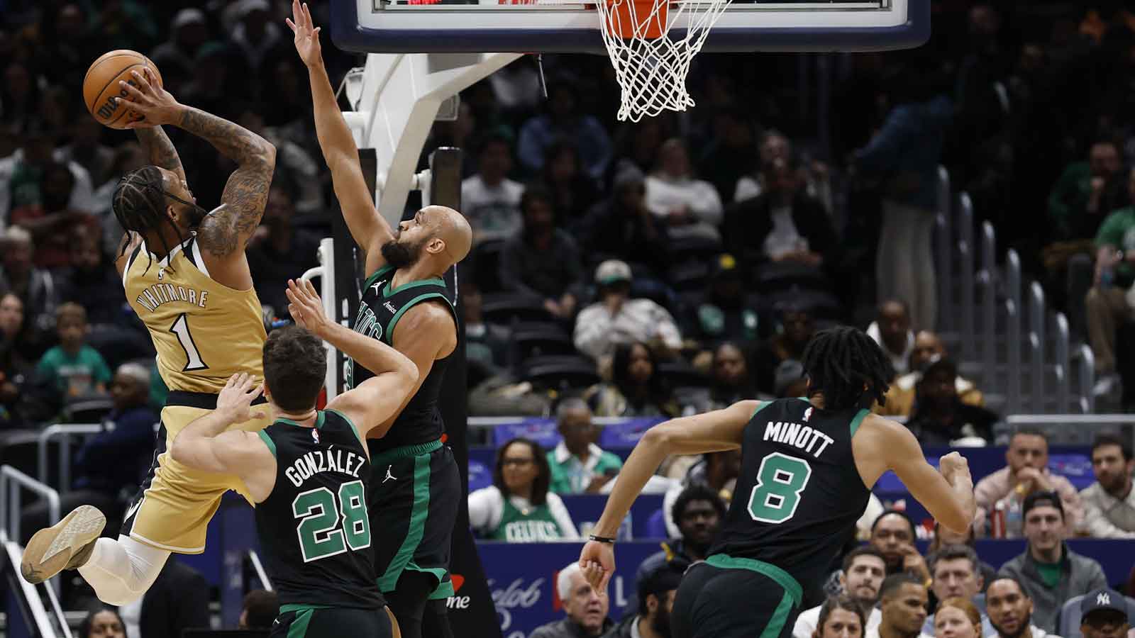 Washington Wizards forward Cam Whitmore (1) shoots the ball as Boston Celtics guard Derrick White (9) defends in the first half at Capital One Arena.