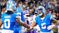 Detroit Lions running back David Montgomery (5) celebrates a touchdown against Minnesota Vikings with running back Jahmyr Gibbs (0) during the first half at Ford Field in Detroit on Sunday, November 2, 2025.