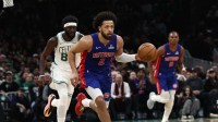 Detroit Pistons guard Cade Cunningham (2) brings the ball up the court against the Boston Celtics during the first quarter at TD Garden.